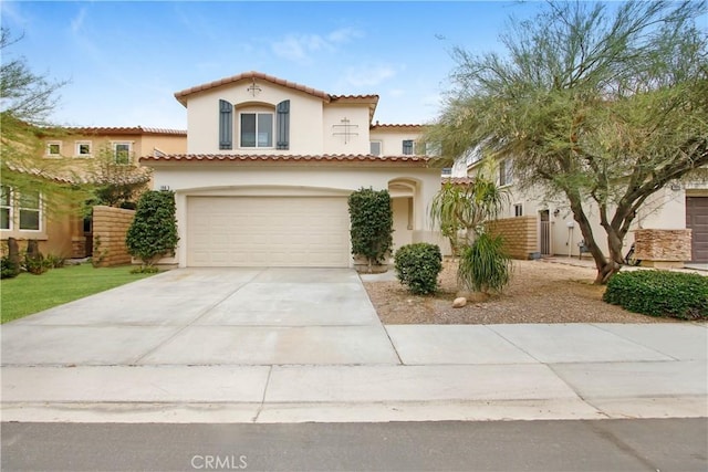 mediterranean / spanish-style home with a garage