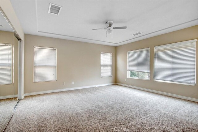 carpeted spare room with ceiling fan