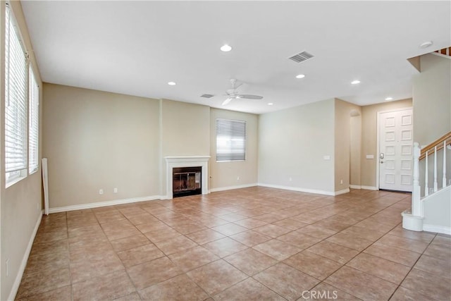 unfurnished living room featuring ceiling fan and light tile patterned flooring