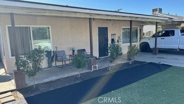 exterior space with central AC and a carport