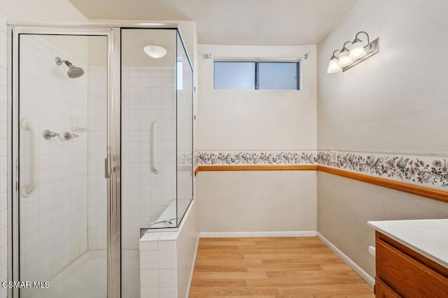 bathroom featuring vanity, a shower with shower door, and wood-type flooring