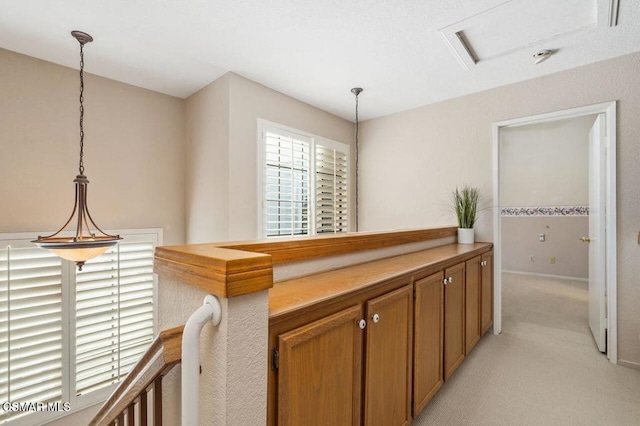 hallway with light colored carpet