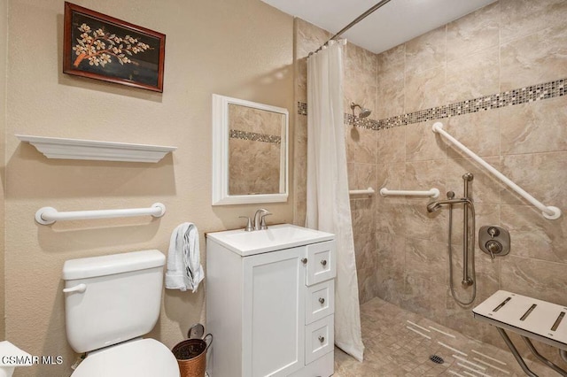 bathroom featuring vanity, toilet, and curtained shower