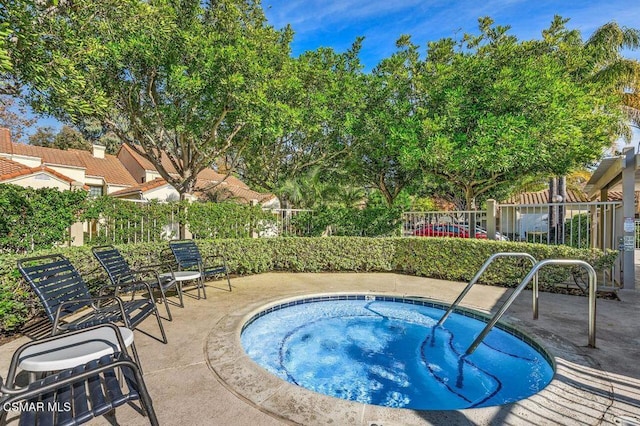 view of pool featuring a hot tub and a patio area