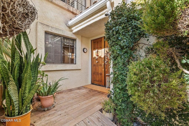 doorway to property with a wooden deck