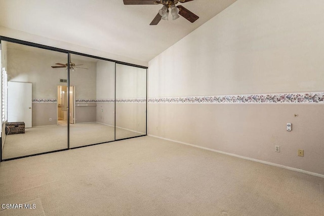 unfurnished bedroom with carpet flooring, ceiling fan, lofted ceiling, and a closet