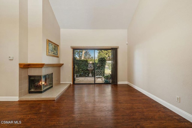 unfurnished living room featuring a fireplace, wood-type flooring, and lofted ceiling