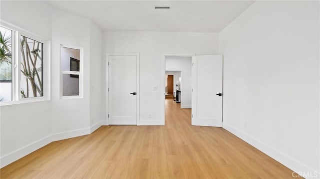 empty room with light hardwood / wood-style floors