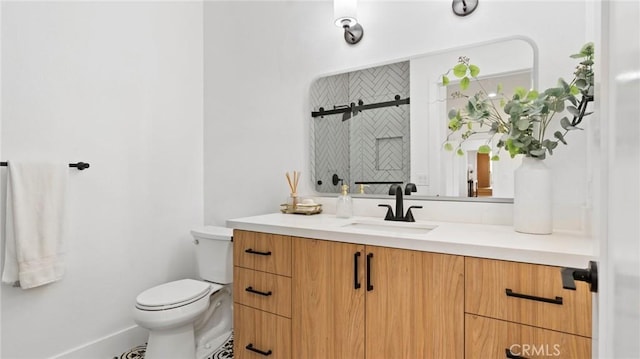 bathroom featuring toilet and vanity