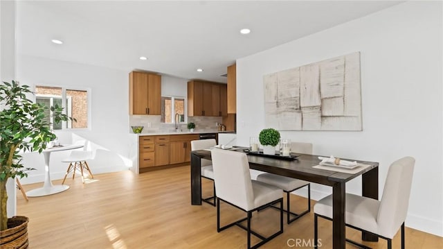 dining space with light hardwood / wood-style floors and sink