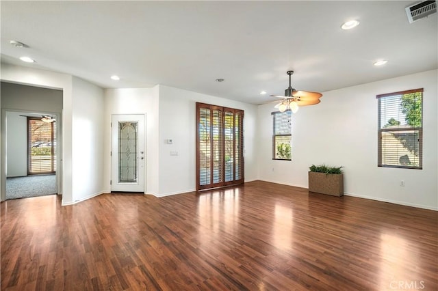 spare room featuring ceiling fan and dark hardwood / wood-style floors