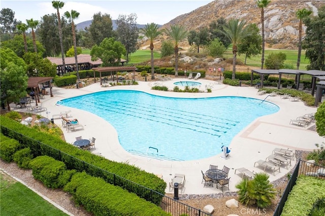 view of pool with a patio area and a mountain view