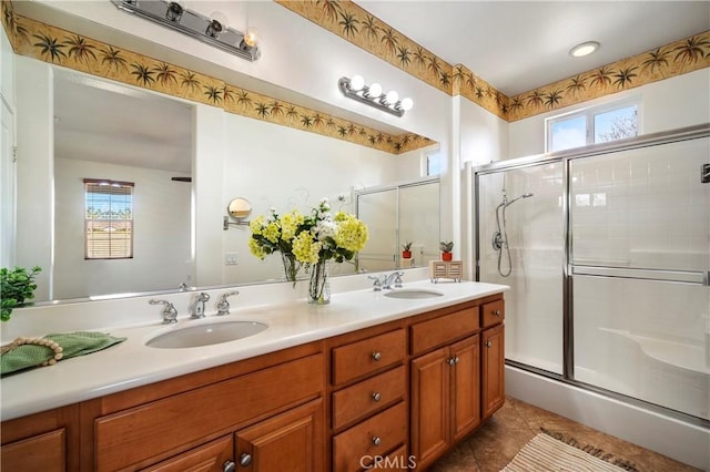 bathroom with vanity, tile patterned floors, and a shower with door