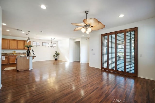 living room featuring ceiling fan with notable chandelier and dark hardwood / wood-style floors