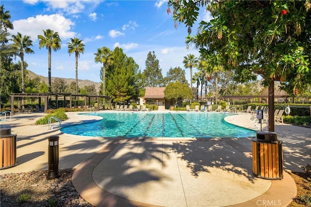 view of pool featuring a mountain view and a patio area