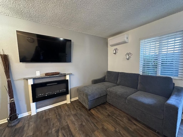 living room with dark hardwood / wood-style floors, a wall mounted AC, and a textured ceiling