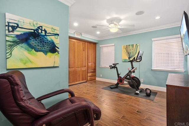 exercise area with hardwood / wood-style floors, ceiling fan, and ornamental molding