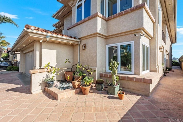 exterior space featuring a patio and a garage