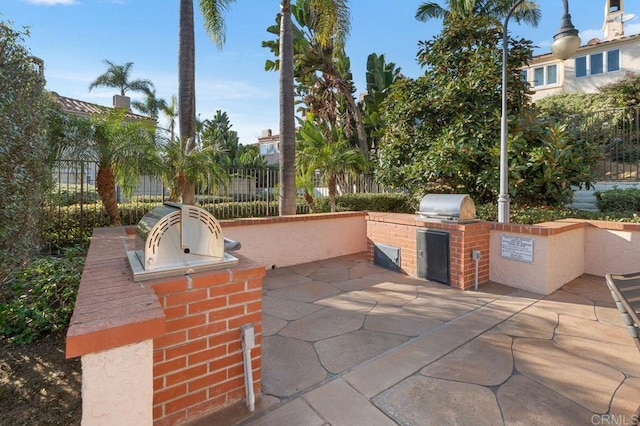 view of patio / terrace featuring an outdoor kitchen and a grill