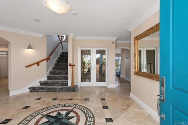 entrance foyer with crown molding and french doors