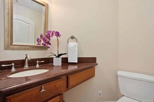 bathroom with toilet and vanity