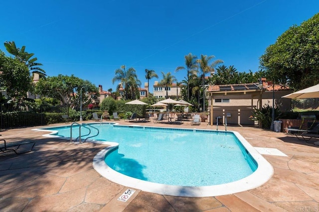 pool with fence and a patio