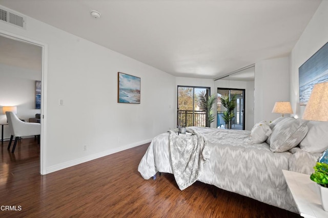 bedroom with dark hardwood / wood-style flooring and access to outside