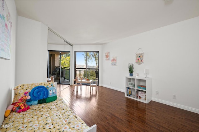 sitting room with dark hardwood / wood-style flooring