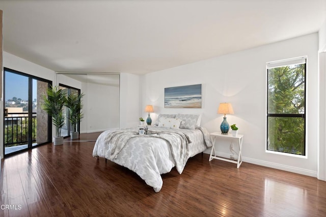 bedroom featuring access to outside and dark hardwood / wood-style flooring