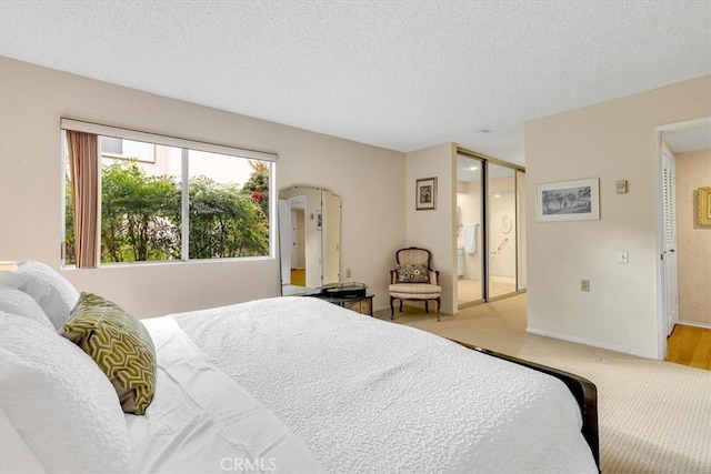 bedroom featuring carpet flooring, a textured ceiling, and a closet