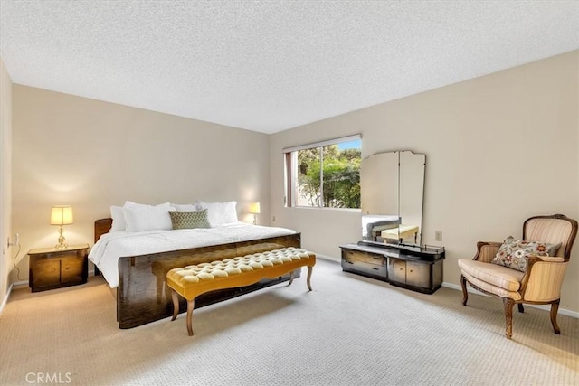 bedroom featuring a textured ceiling and light carpet