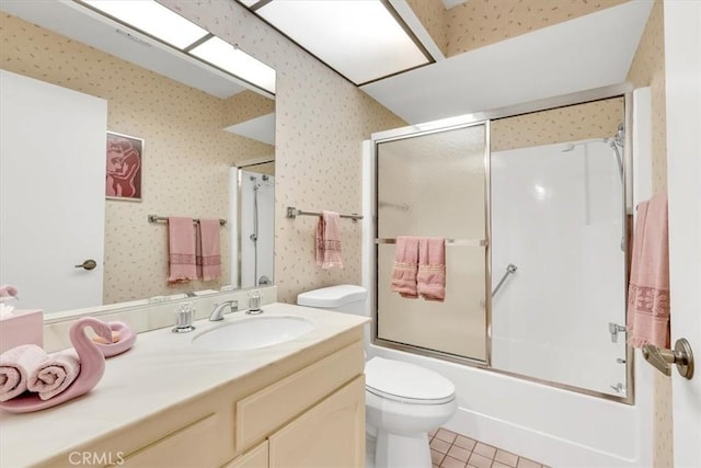 full bathroom featuring tile patterned flooring, vanity, enclosed tub / shower combo, and toilet