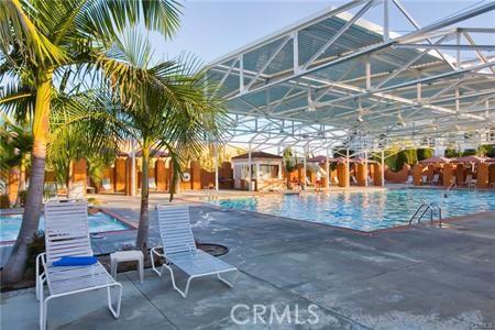 view of pool featuring glass enclosure and a patio area