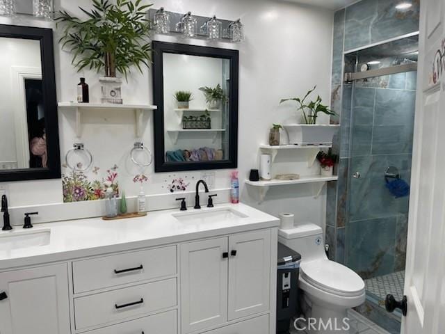 bathroom featuring walk in shower, vanity, and toilet