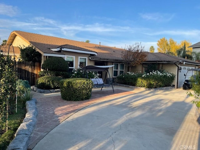 view of front of property featuring a garage and a patio area