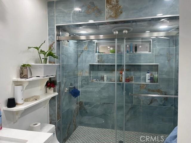 bathroom featuring an enclosed shower, vanity, and toilet