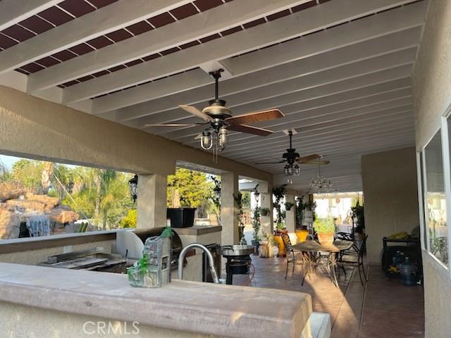 view of patio / terrace with a wet bar and ceiling fan