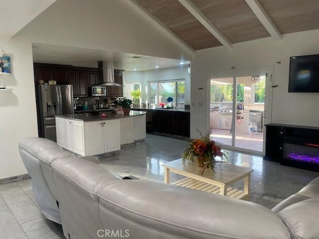 living room featuring wood ceiling and lofted ceiling with beams