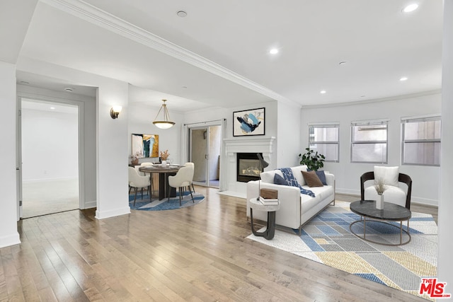 living room with crown molding and hardwood / wood-style flooring