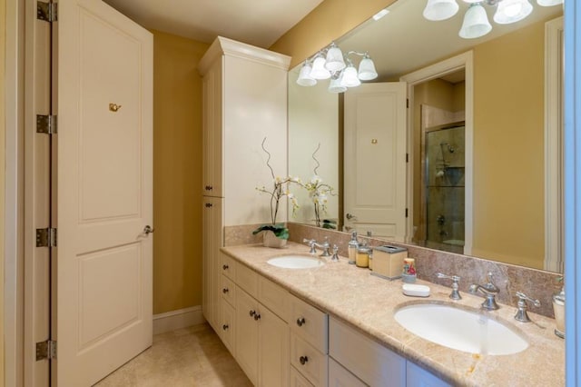 bathroom featuring a notable chandelier, vanity, and a shower with shower door