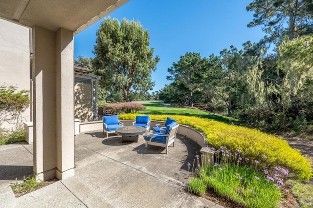 view of patio / terrace featuring an outdoor fire pit