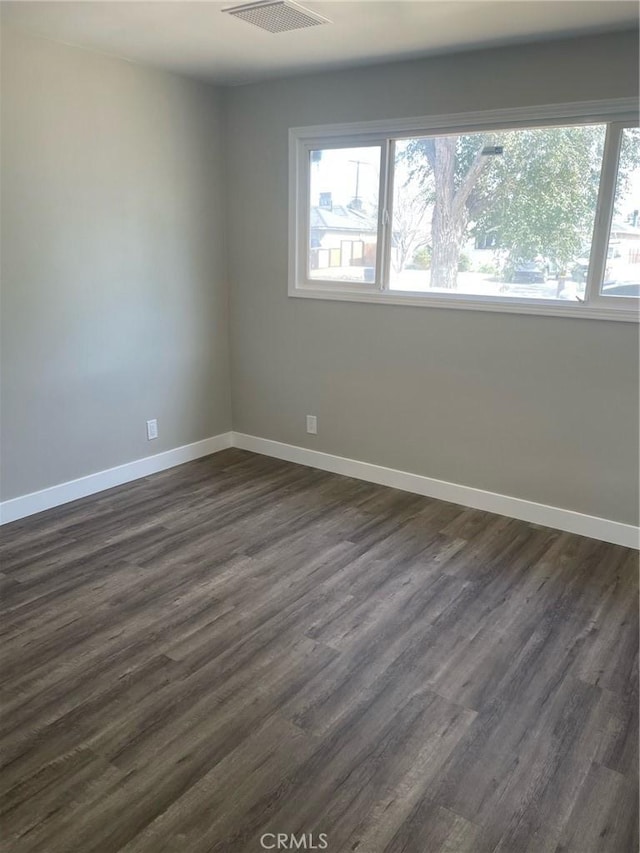 empty room with dark hardwood / wood-style floors