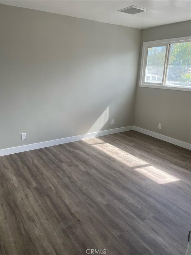 spare room with dark hardwood / wood-style floors