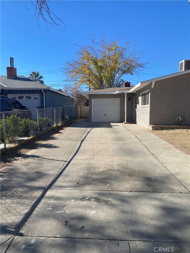 exterior space featuring a garage and central AC unit