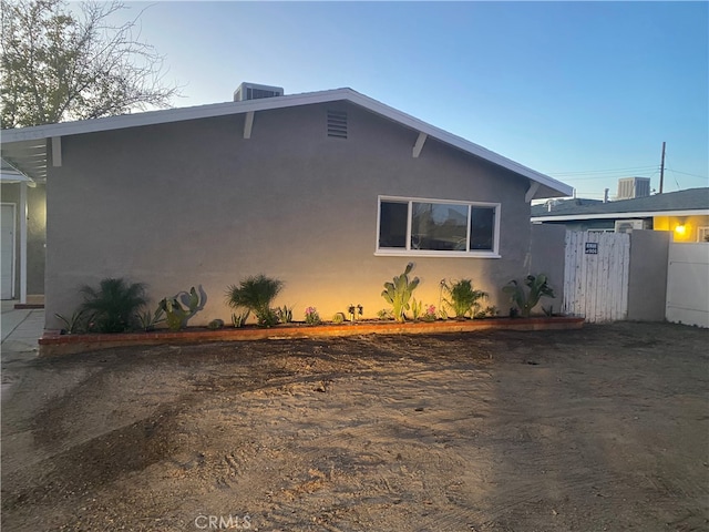 property exterior at dusk with central AC unit