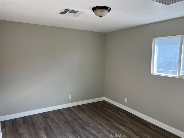 spare room with dark wood-type flooring