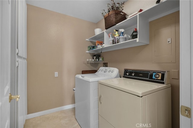 laundry room with washer and dryer, light tile patterned floors, and electric panel