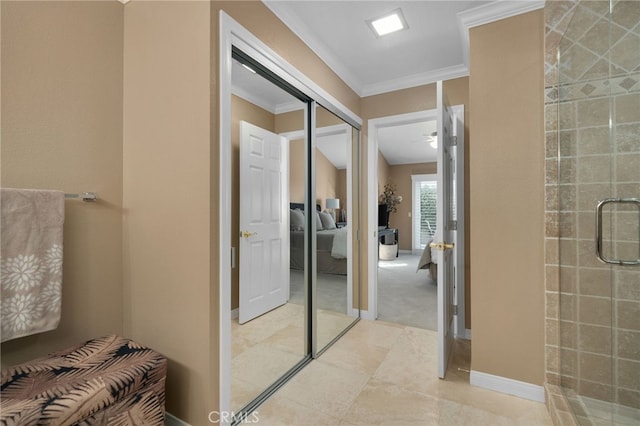 bathroom with an enclosed shower and ornamental molding