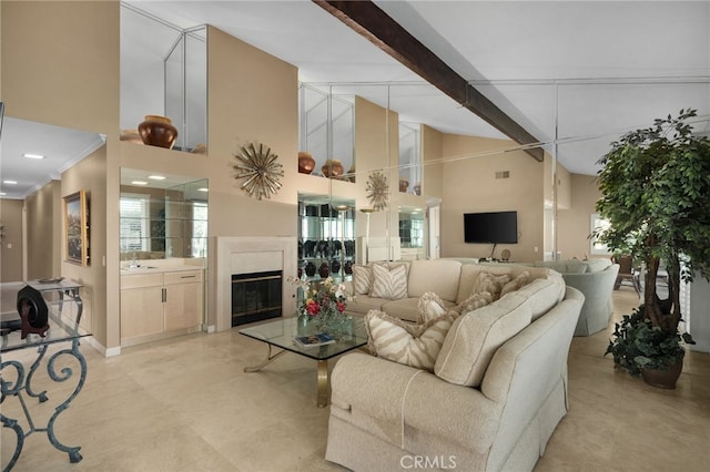 living room featuring beam ceiling, a high end fireplace, plenty of natural light, and a towering ceiling