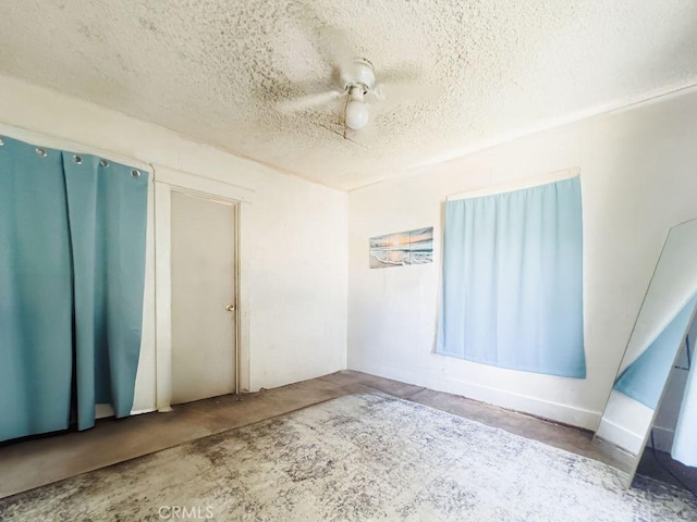 unfurnished room with concrete floors and a textured ceiling